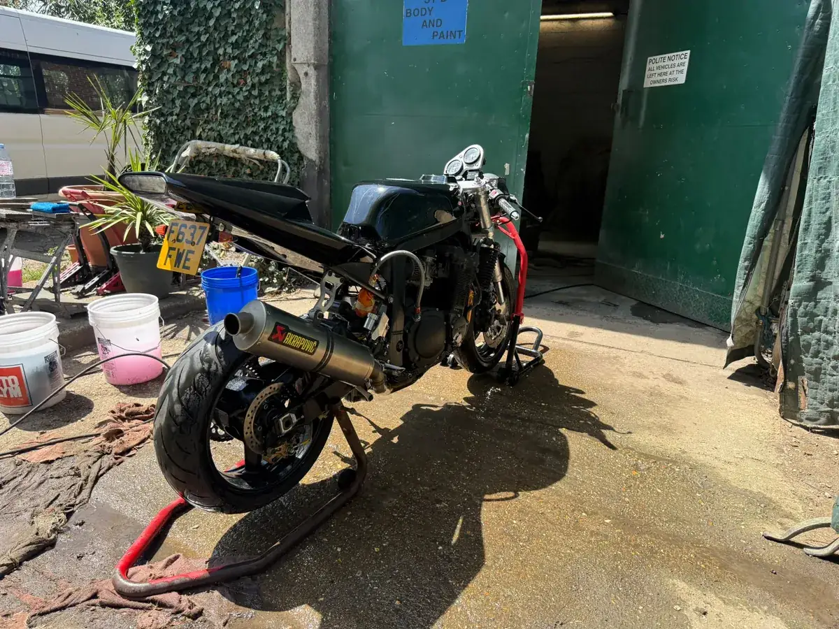 Streetfighter rear three quarter by the unit doors, Akrapovic exhaust visible