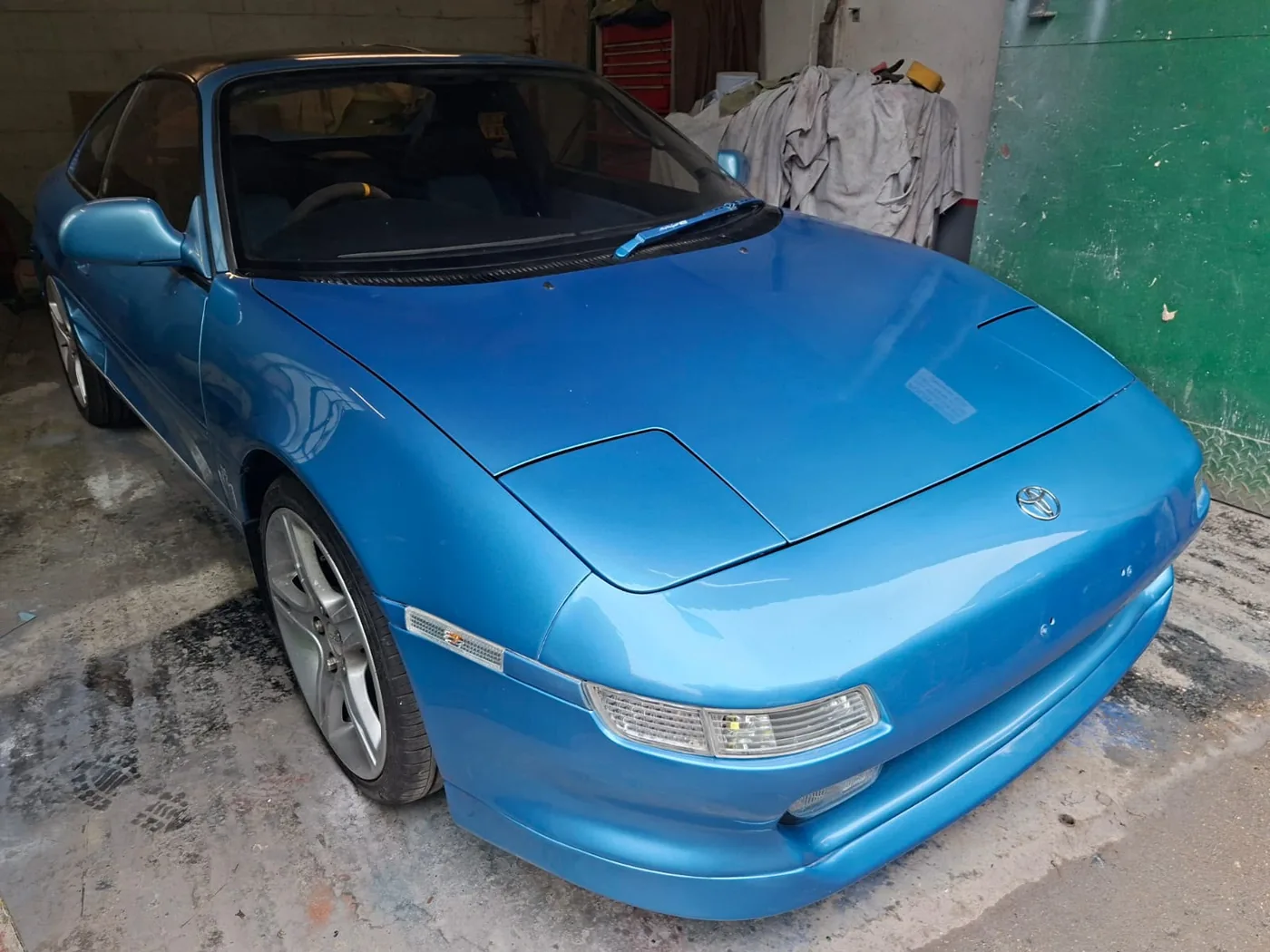 The same classic coupe resprayed back to a deep, even blue gloss