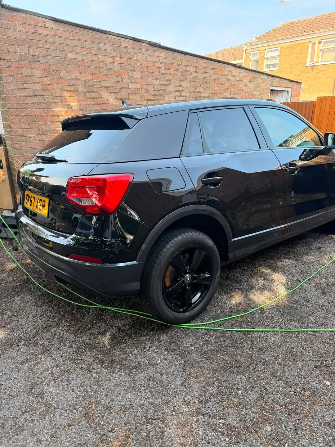 Audi Q2 rear three quarter, gloss black alloys and dressed tyres