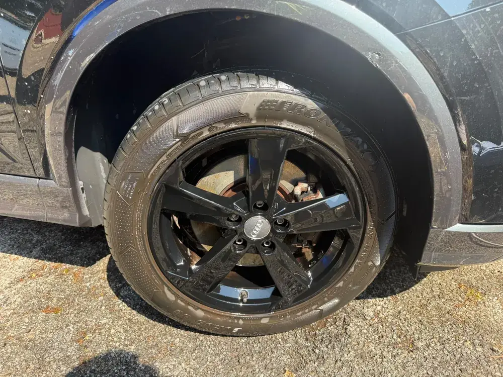 Audi alloy wheel caked in brake dust and road grime before cleaning